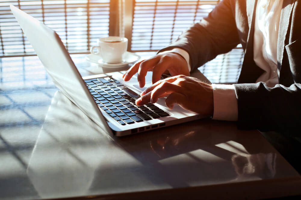 hands of business man working on laptop