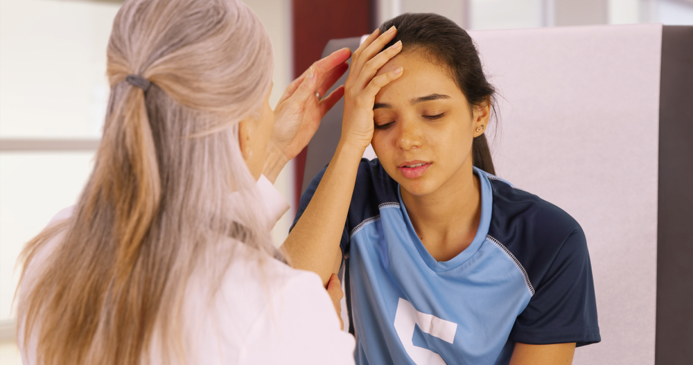 A concussed soccer player seeks help at the doctors office