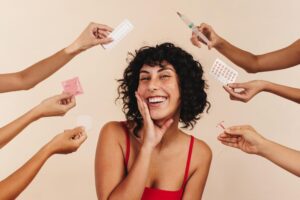 Smiling woman with hands holding contraceptive options for women