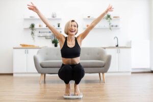 Happy woman celebrating successful weight loss