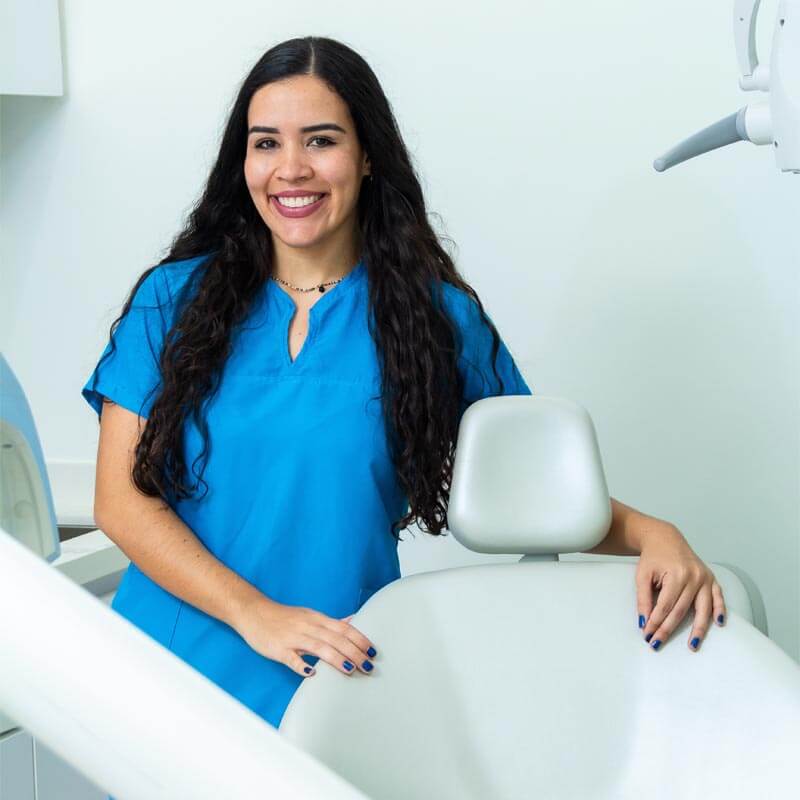 woman dentist next to dental chair at modern dental clinic