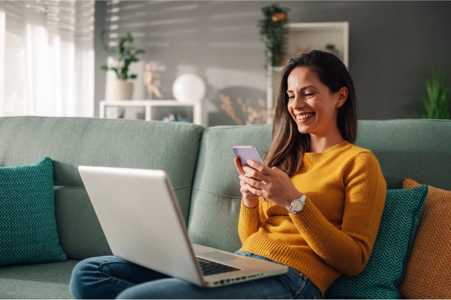 woman using laptop and a phone