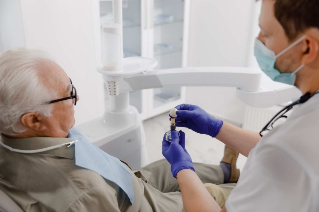 Dentist holding implant for procedure