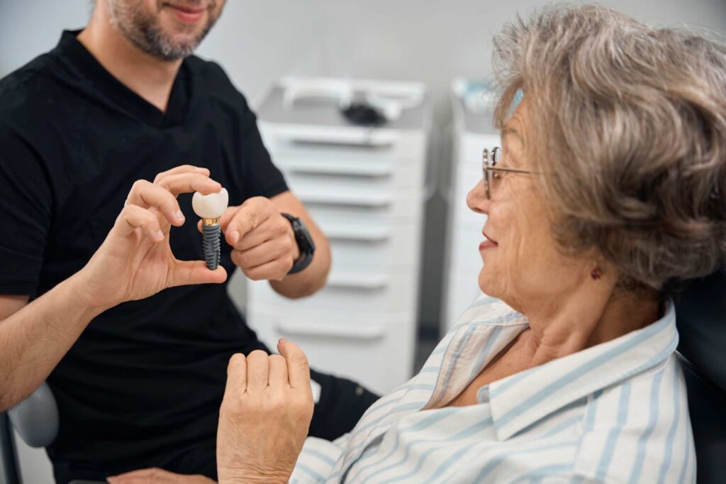 Dentist holding implant for procedure