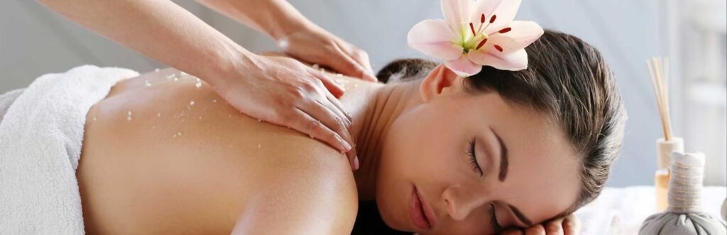 Beautiful woman having relaxing massage on her back in spa salon