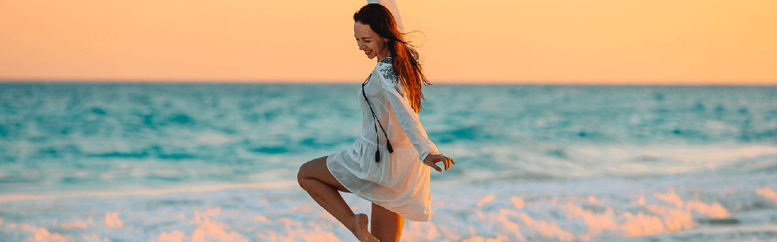 Happy young woman enjoying at beach