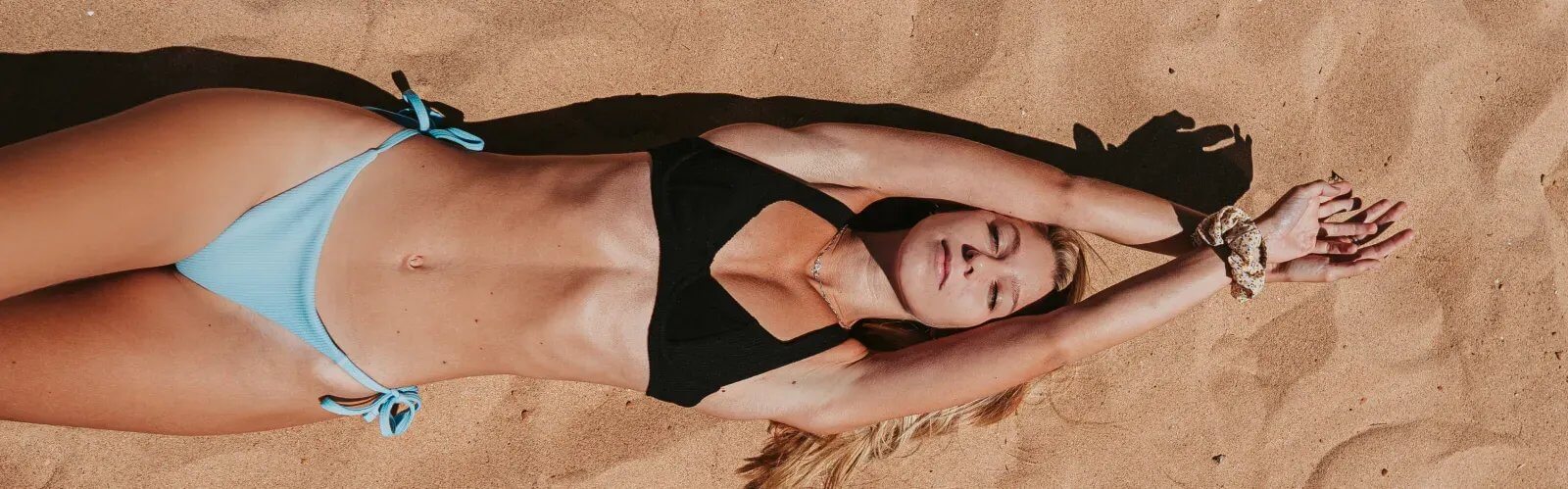 Woman lying on beach sand relaxing on beach
