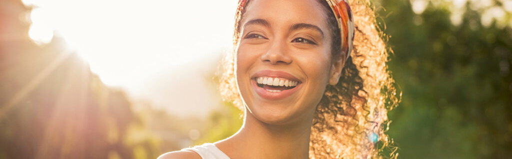 beautiful woman smiling and looking away at park