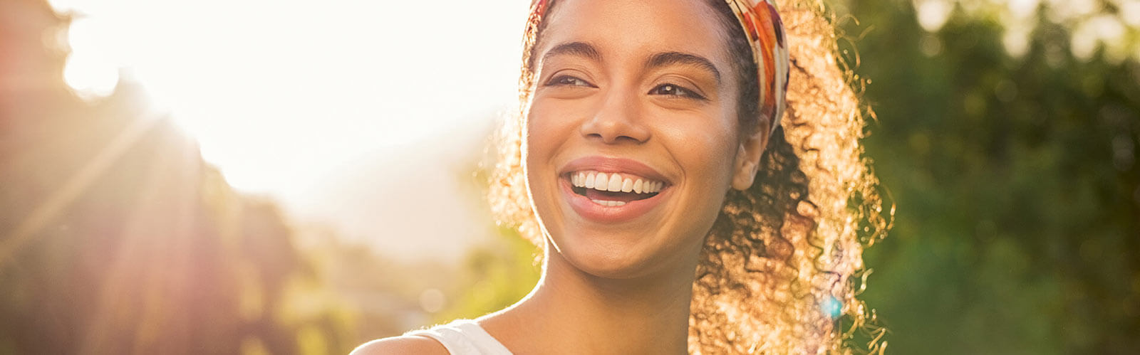 beautiful woman smiling and looking away at park