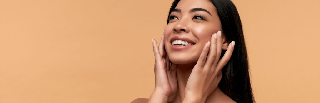 Young beautiful woman massaging face
