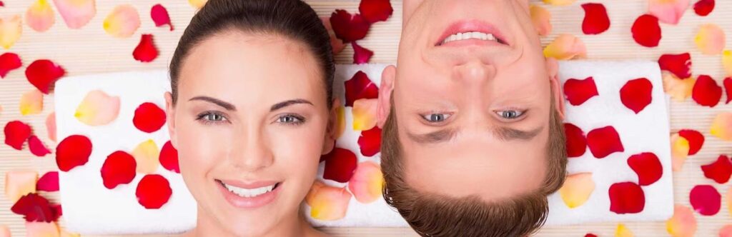 Beautiful young couple relaxes lying in rose petals
