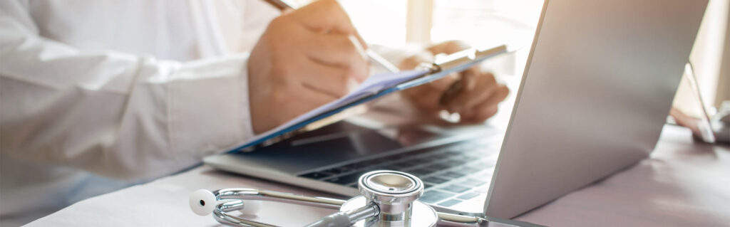 Medicine doctor's writing on laptop in medical office