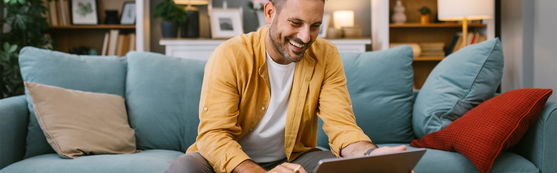 Happy man working from home on a laptop