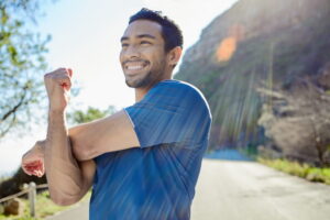 Fitness, thinking and stretching with a man runner outdoor
