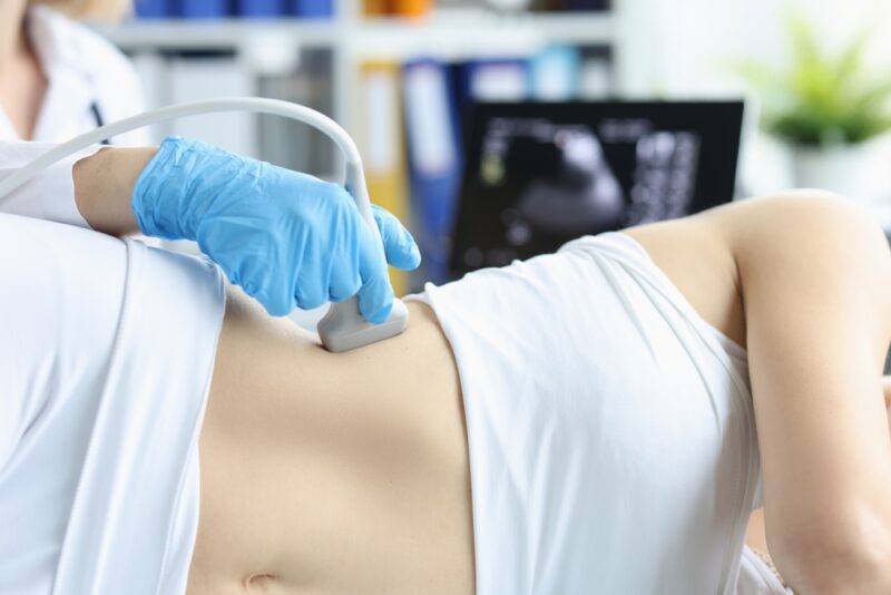 Doctor making ultrasound of kidneys to patient in clinic closeup