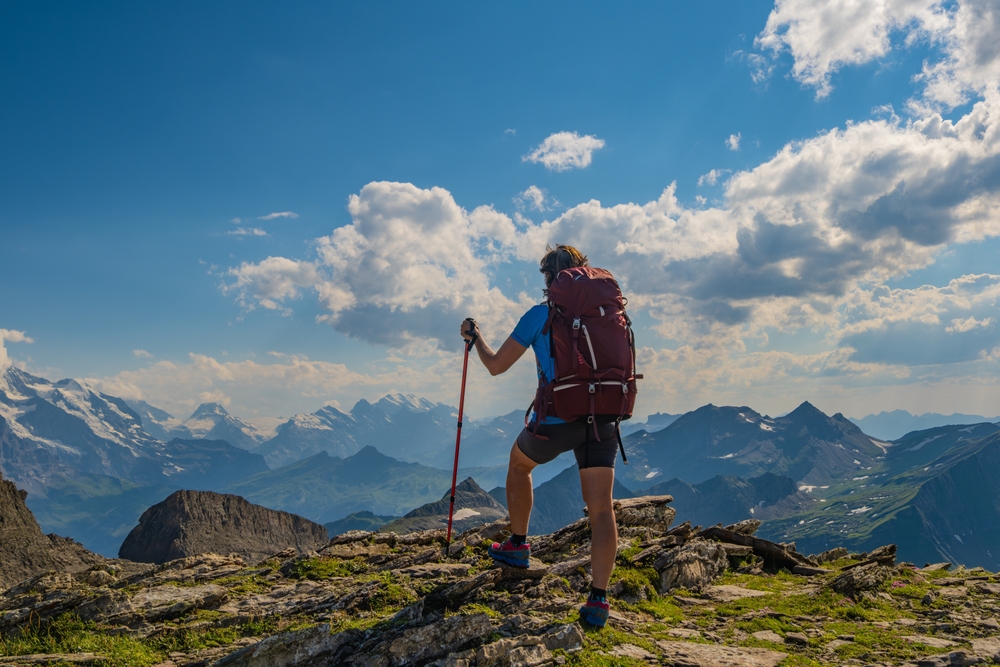 active man is hiking in the mountains