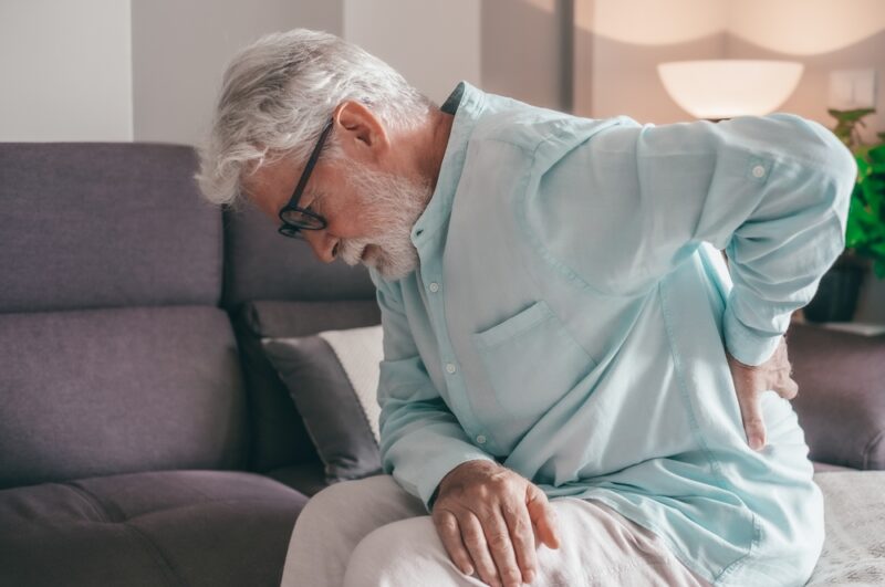 Senior elder man feel sudden back pain muscles ache tension injury at home