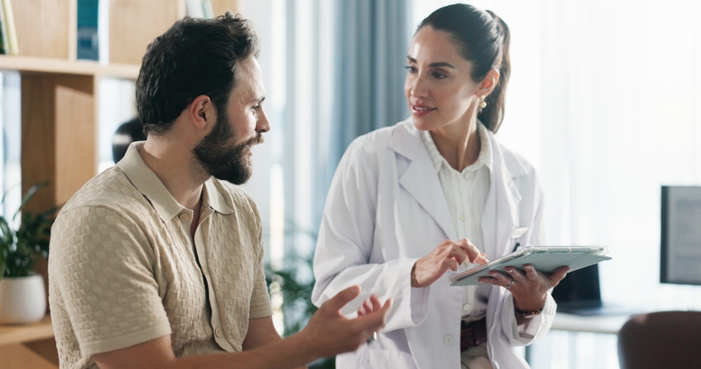 Doctor, patient or consulting with tablet for health advice, checkup or visit at clinic appointment