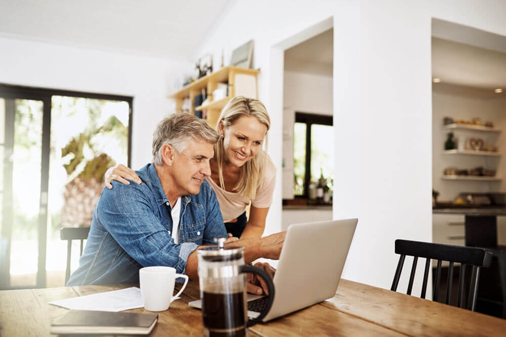 Couple with laptop planning finance