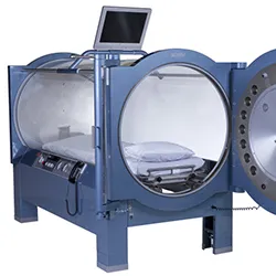 a monoplace hyperbaric oxygen chamber, specifically a Sechrist H-series model used for Hyperbaric Oxygen Therapy (HBOT)