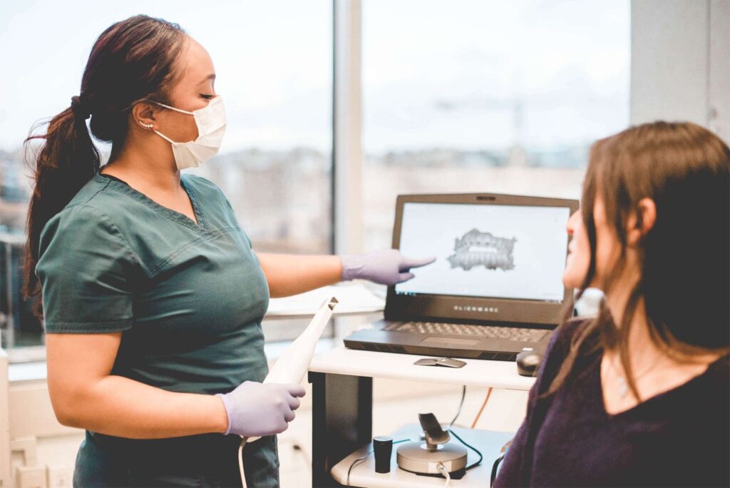 Team member showing dental scan to patient