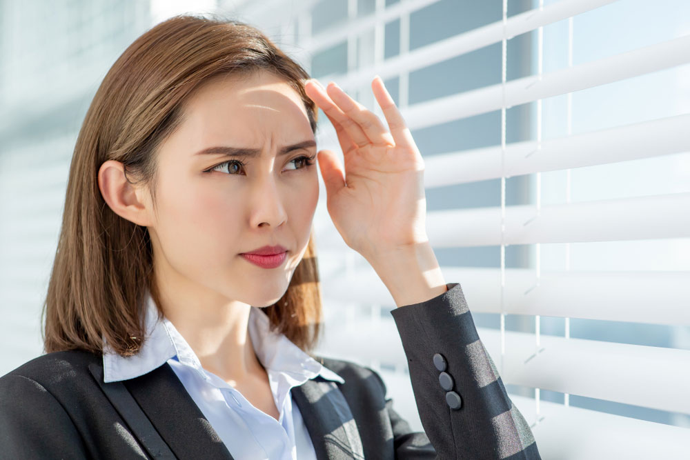 Young asian business woman dislike the sunshine because afraid of suntan