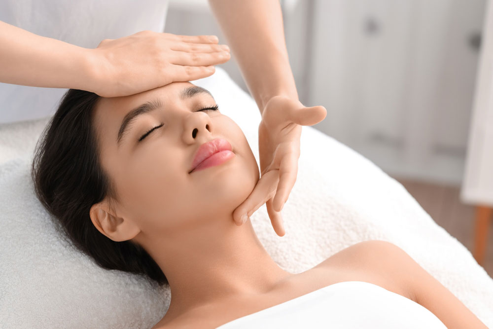 Young woman having facial massage in salon, closeup