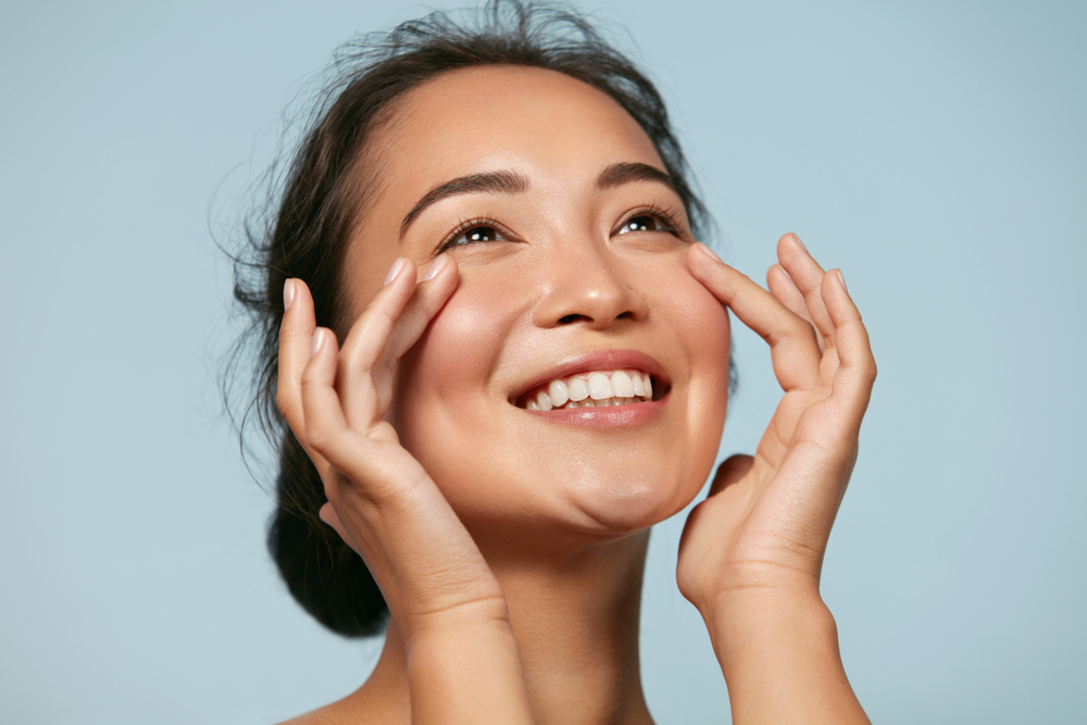 Skin care woman with beauty face touching healthy facial skin