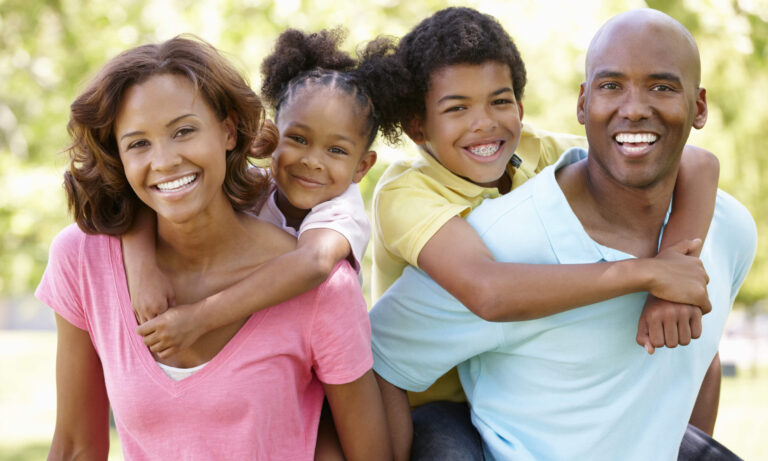 happy family carrying their kids on the back