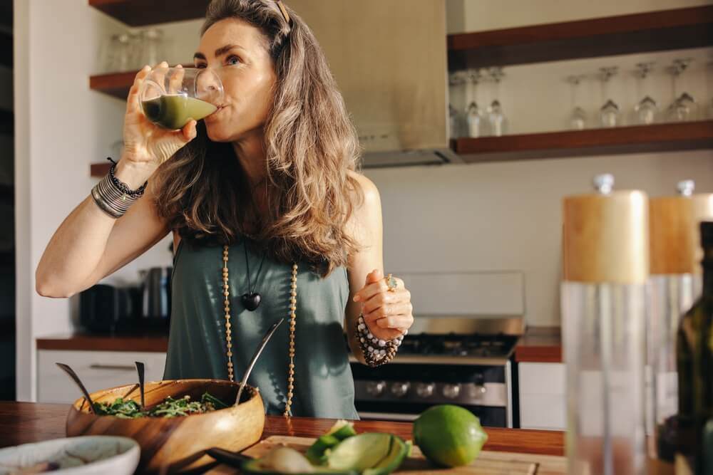 Woman drinking some green juice