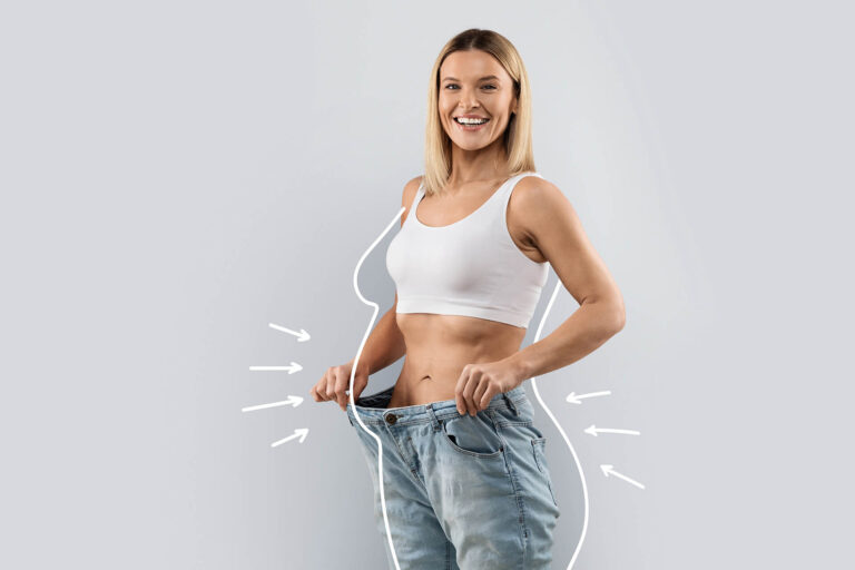 Cheery attractive woman wearing huge jeans, showing results of diet