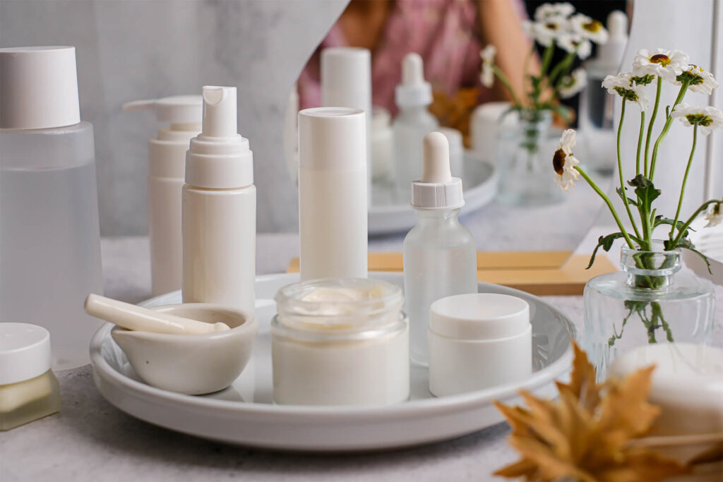 The collection of white skincare products on a tray for beauty and self-care routines