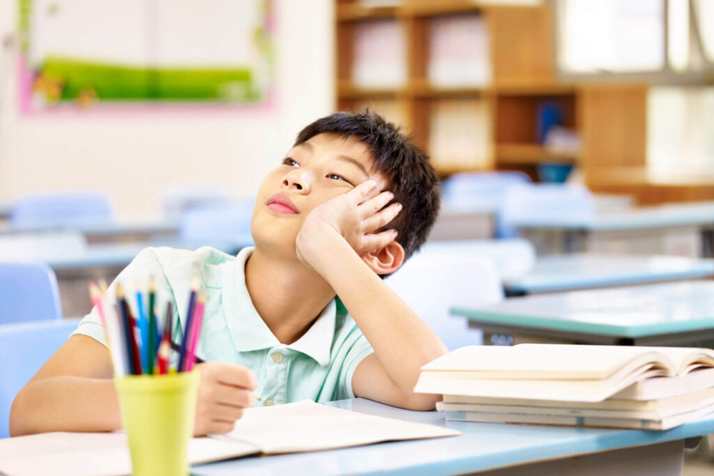 Boy thinking during class time.