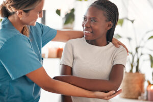 Physiotherapy, stretching arm and black woman muscle massage, healthcare service and anatomy or elbow healing. Physical therapy, medical professional support or chiropractor consulting happy patient