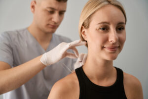 Male reflexologist conducts an acupuncture session for an expectant mother