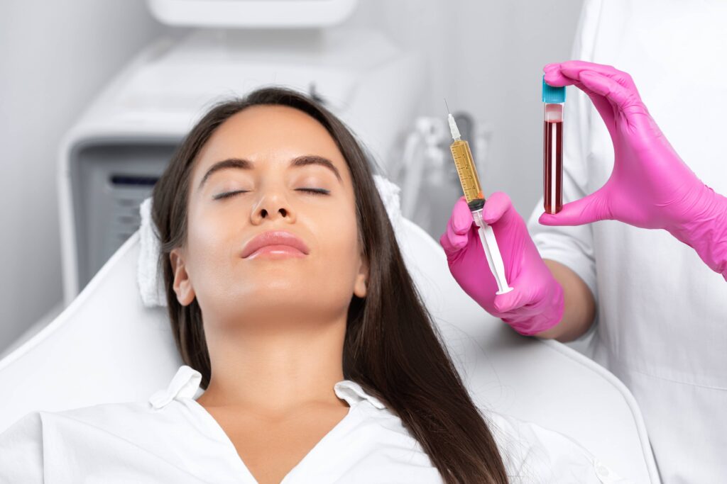 Beautician will do PRP therapy for the face against wrinkles and against hair loss of a beautiful woman in beauty salon