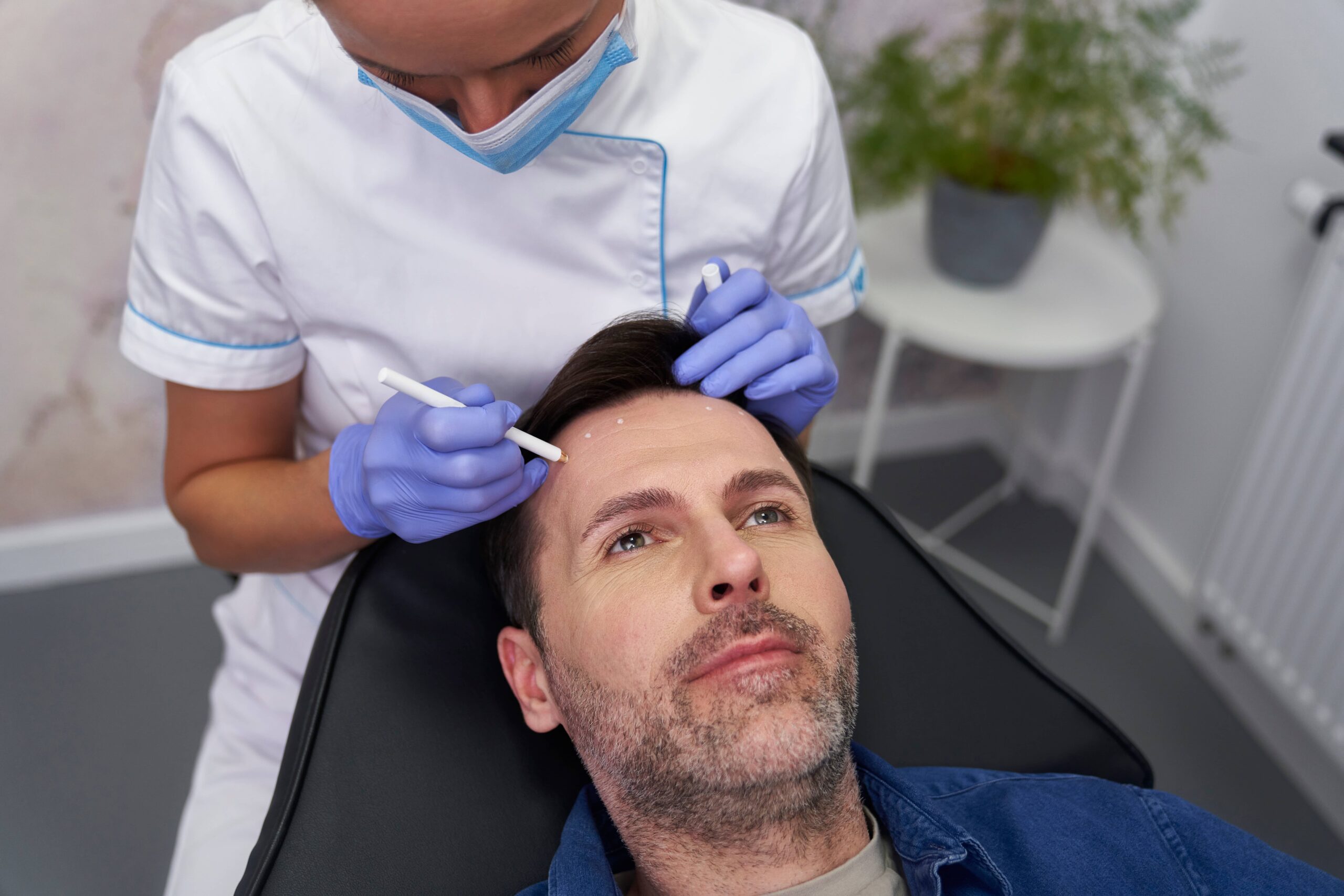 Man having face-lifting procedure in beauty salon