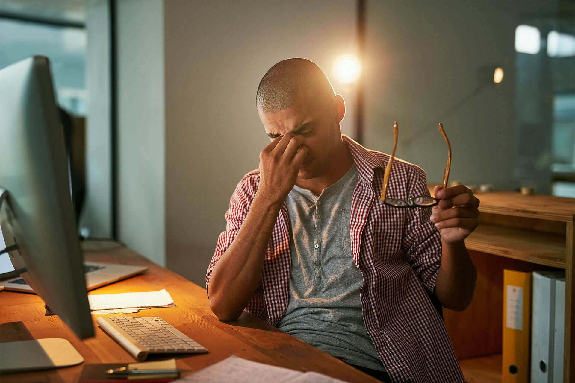 Stressed man with headache in office