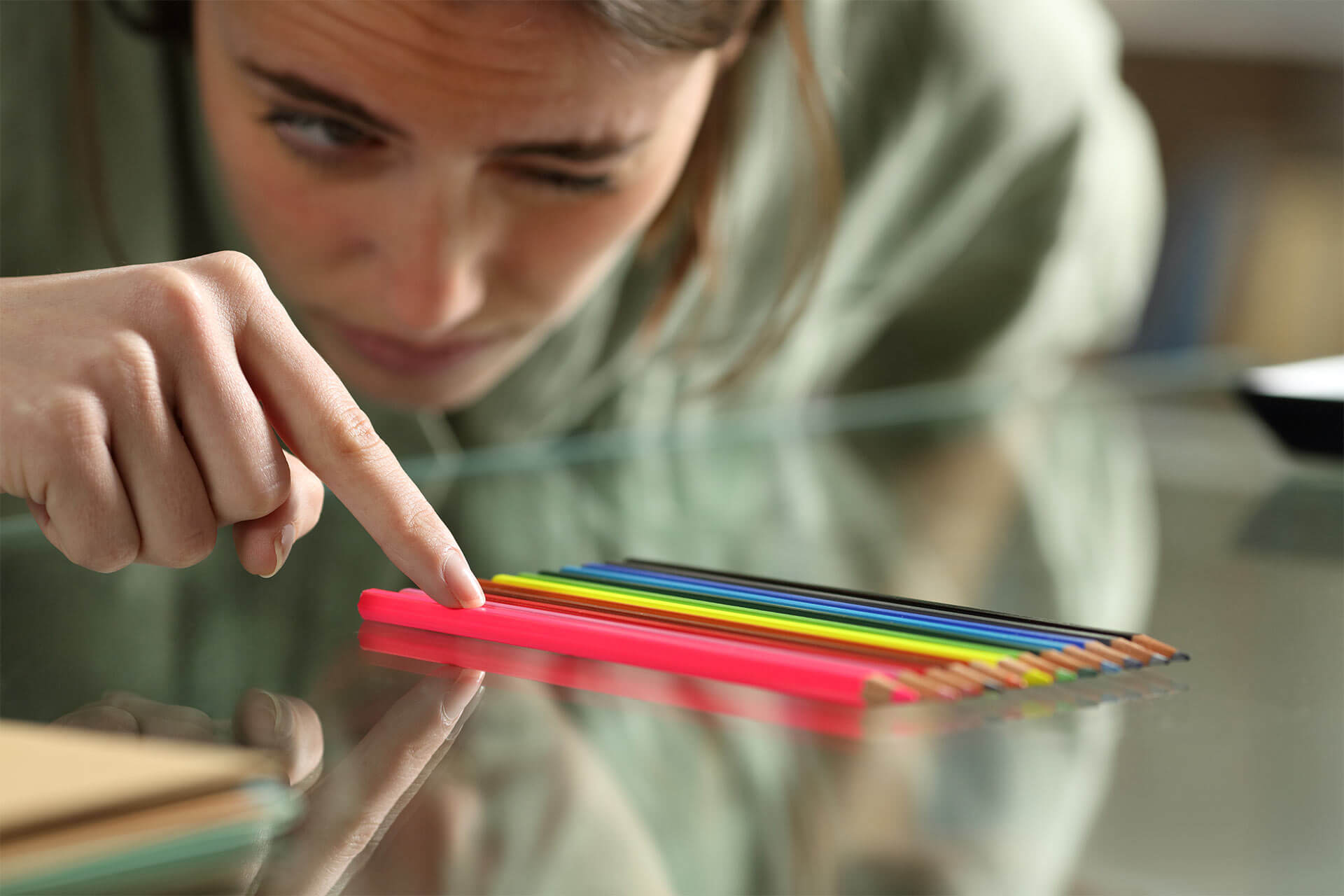 Obsessive compulsive woman aligning up pencils accurately