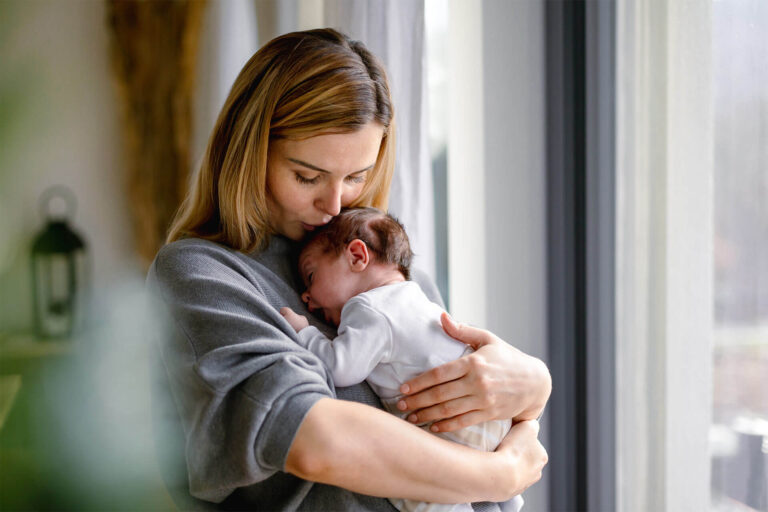 woman carrying her baby