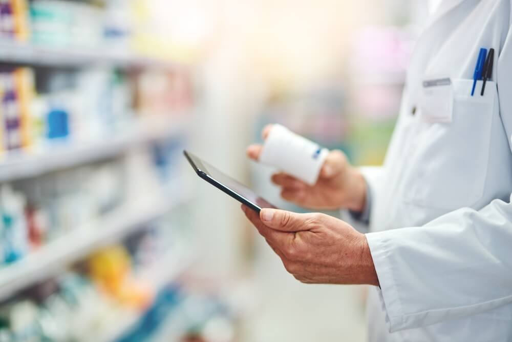 Pharmacy, pills and tablet with hands of person for medicine, advice and healthcare