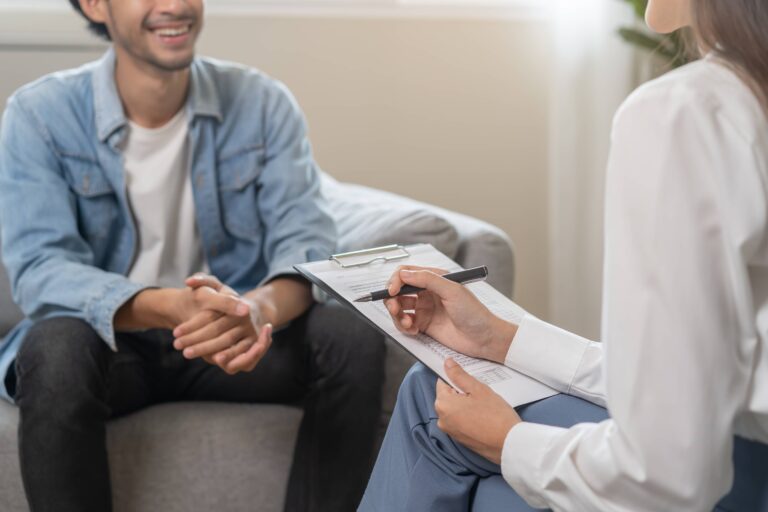 Psychologist with happy young male patient