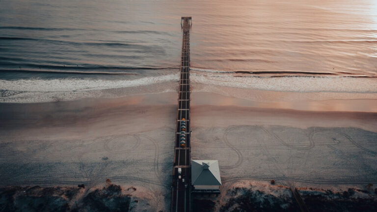 beach with a long pier