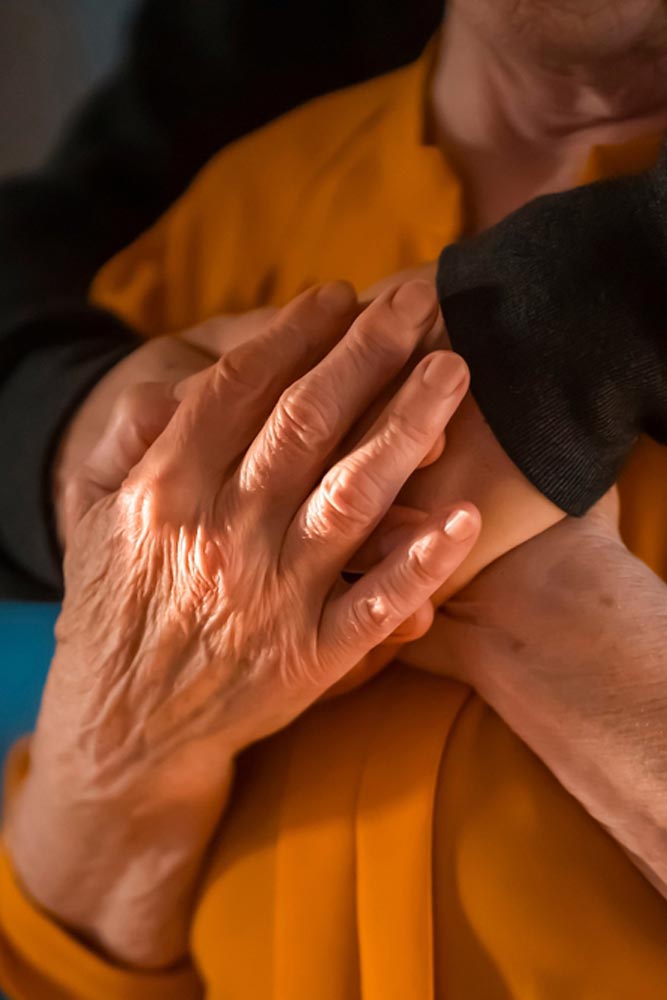 old woman holding hands