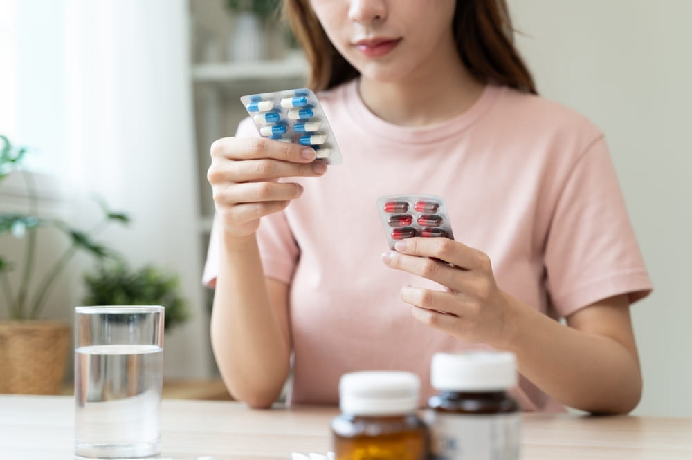 Close-Up Hands Holding Medication and Water Glass for Optimal Wellness