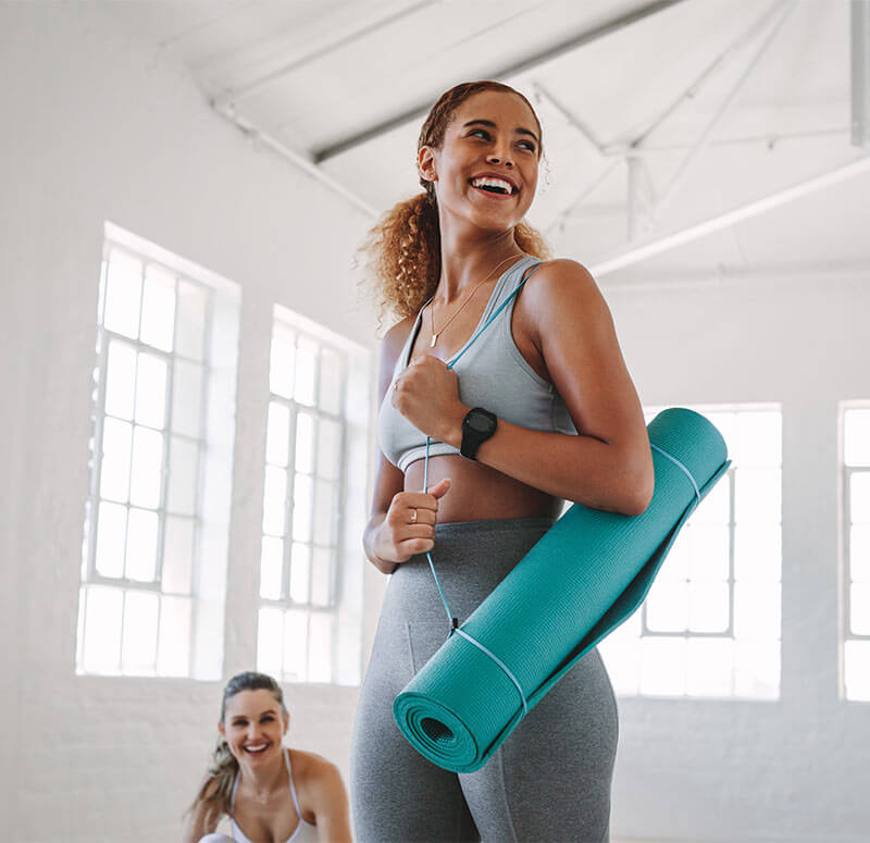 woman carrying yoga mat
