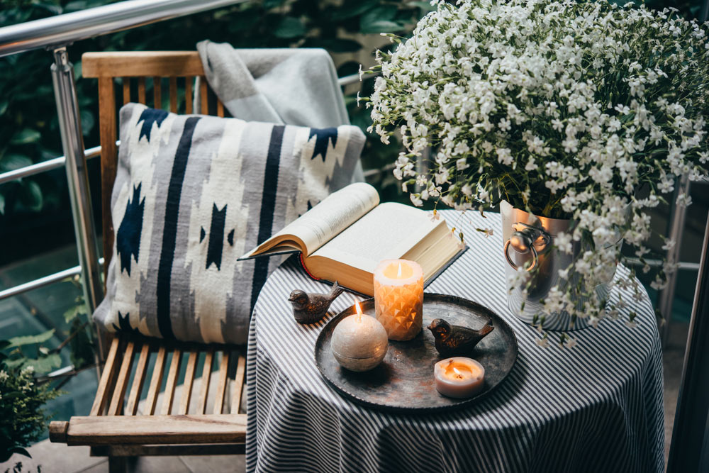 Beautiful terrace or balcony with small table, candles and flowers