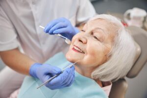 Close up portrait of elderly beautiful woman check up and having the consultation with dentist at the dental office