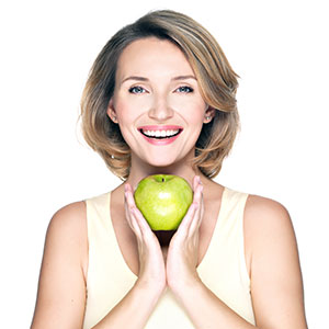 woman holding green apple