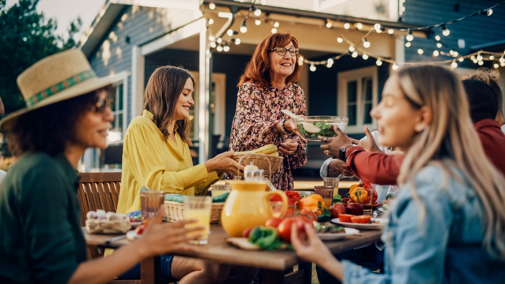 Family and Multiethnic Diverse Friends Gathering Together at a Garden Table